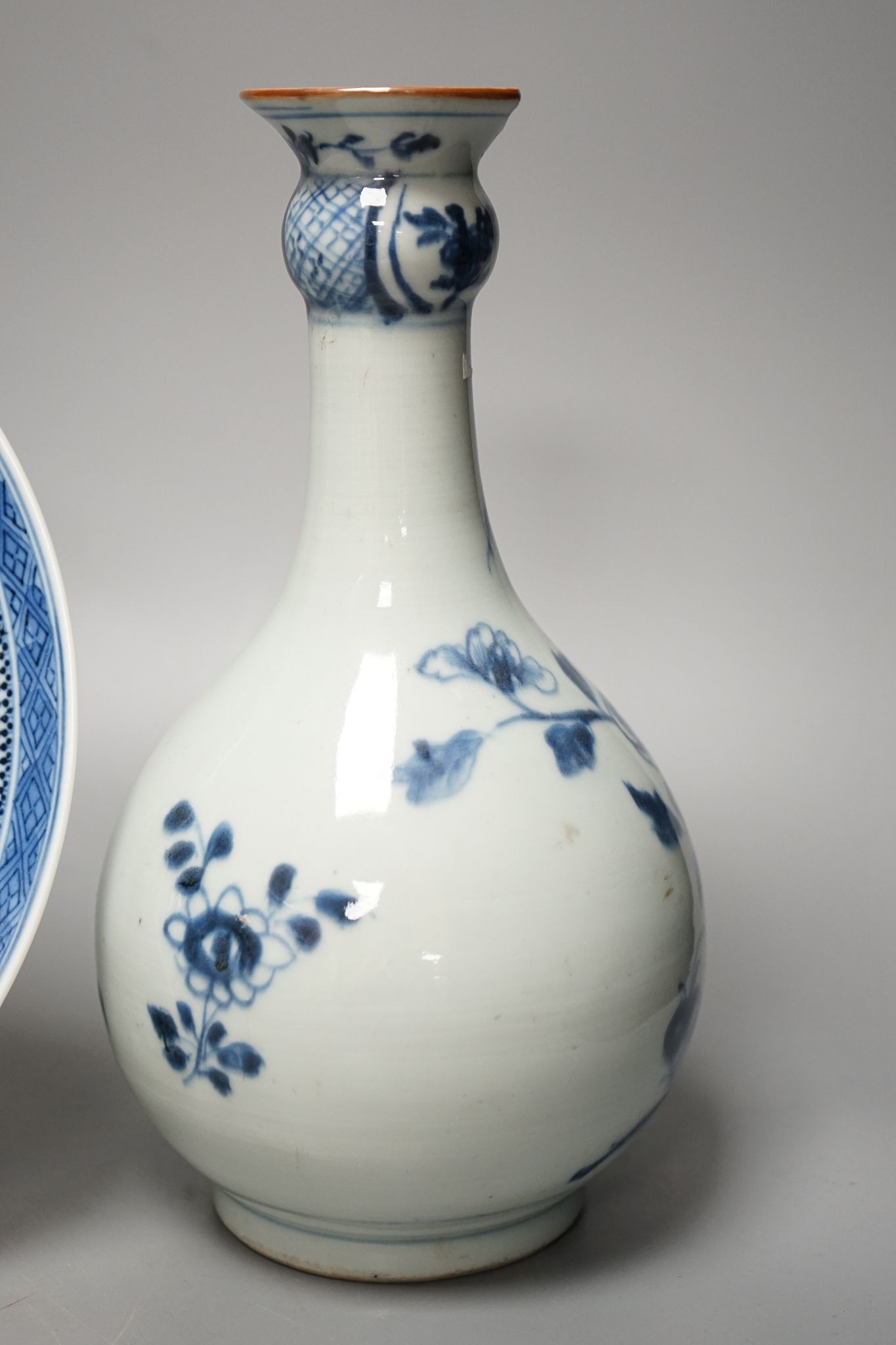 An 18th century Chinese blue and white bottle vase and two 19th century blue and white plates, diameter of largest plate - 25cm